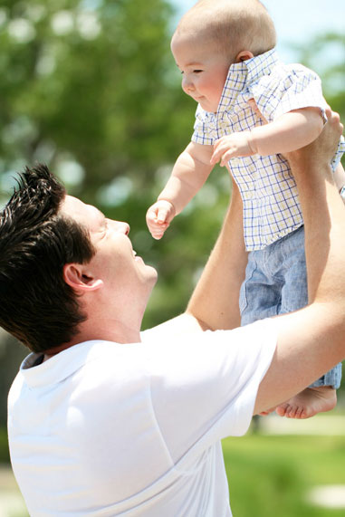 Father lifting son in the air